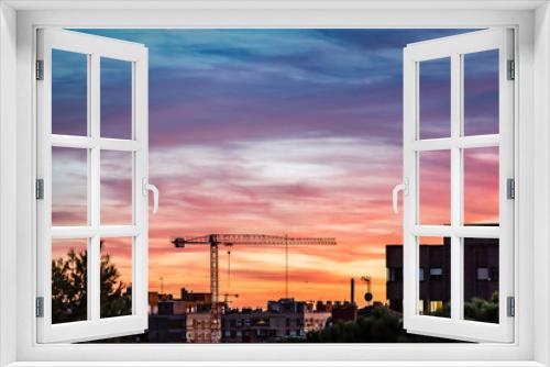 Fototapeta Naklejka Na Ścianę Okno 3D - Construction crane on Madrid skyline at beautiful sunset