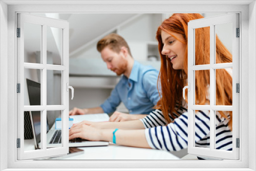 Colleagues working studying in white office