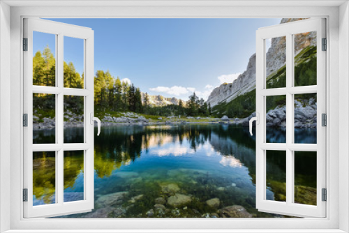 Fototapeta Naklejka Na Ścianę Okno 3D - Stunning early morning view of Double Lake (Dvojno jezero) and Triglav Lakes Lodge (Koča pri Triglavskih jezerih) in the background, located in Triglav National Park in the Julian Alps,  Slovenia.