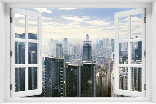 Fototapeta Naklejka Na Ścianę Okno 3D - Jakarta cityscape with modern office buildings and apartments under blue sky