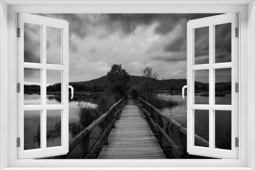 Fototapeta Naklejka Na Ścianę Okno 3D - a wood bridge on a lake