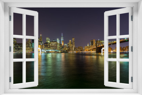 Fototapeta Naklejka Na Ścianę Okno 3D - View on skyscrapers in lower Manhattan from Brooklyn skyline in New York City at night.