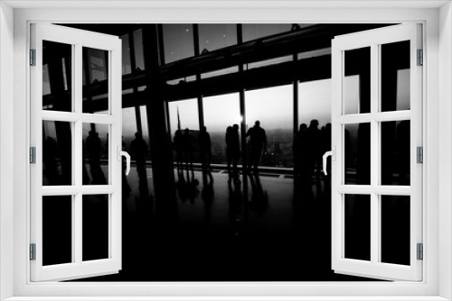 people watch the city from above at panoramic place - black and white image