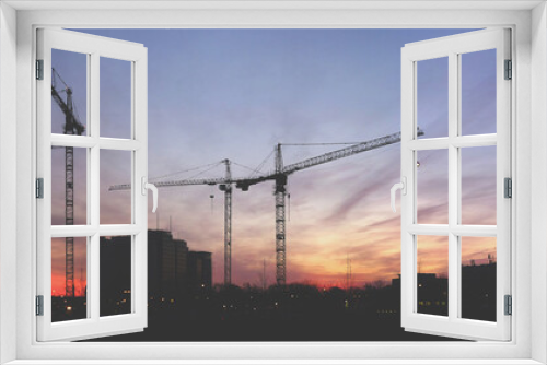 Fototapeta Naklejka Na Ścianę Okno 3D - Cranes at sunrise panorama