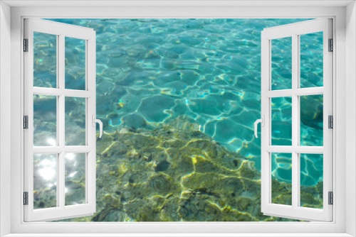 Fototapeta Naklejka Na Ścianę Okno 3D - Crystal turquoise water with twinkling and reflecting sunlight and stones on seabed