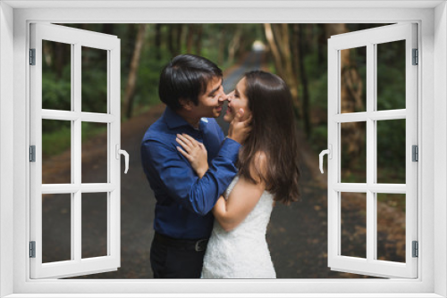 bride and groom newlyweds kissing in woods on green background Wedding Day