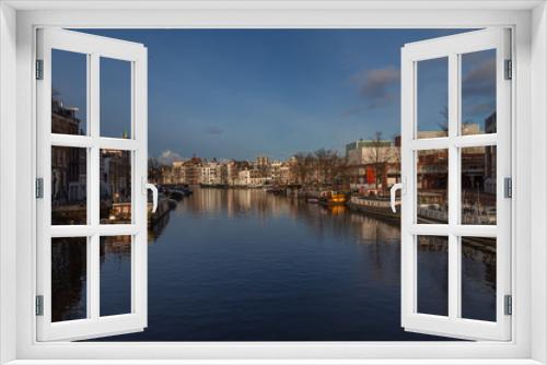 Fototapeta Naklejka Na Ścianę Okno 3D - water canals in Amsterdam with  traditional architecture reflecting in the water on a sunny day