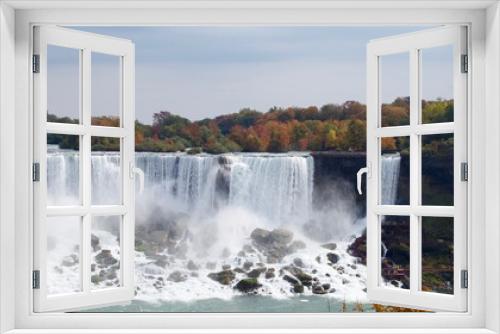 Fototapeta Naklejka Na Ścianę Okno 3D - Beautiful and impressive panorama of the Niagara Falls in Ontario (Canada) on a bright colorful (red, orange, yellow) autumn day with water crashing down the falls onto rocks creating lots of mist