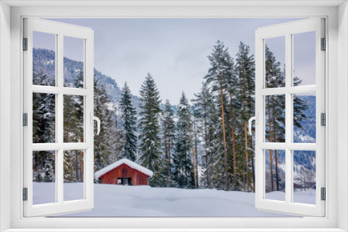 Fototapeta Naklejka Na Ścianę Okno 3D - Astonishing outdoor view of traditional Norwegian mountain red houses of wood covered with snow in the roof in stunning nature background in Norway