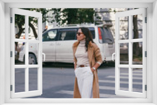 A stylish woman walking on a crosswalk