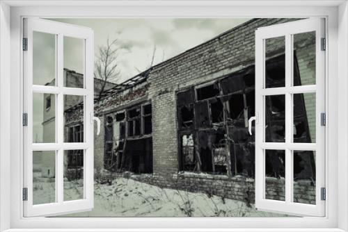 Fototapeta Naklejka Na Ścianę Okno 3D - View of an abandoned dilapidated brick building with big destroyed windows.Toned