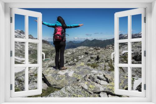Fototapeta Naklejka Na Ścianę Okno 3D - sportive woman standing on top of a mountain in the alps  and enjoying the view