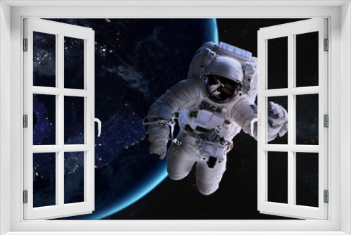 Fototapeta Naklejka Na Ścianę Okno 3D - Astronaut in outer space on background of the night Earth. Elements of this image furnished by NASA.