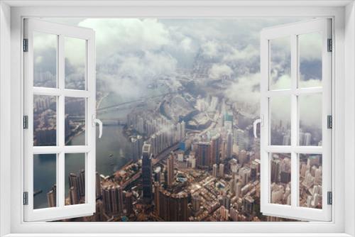 Fototapeta Naklejka Na Ścianę Okno 3D - Aerial view through the clouds to a large metropolis city of Hong Kong.