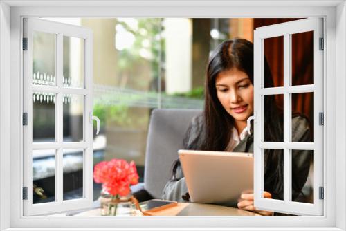 Business Concept.Young Asian businesswoman is working happily.Young businesswoman working in a cafe.Young businesswoman is relaxation in a coffee shop.