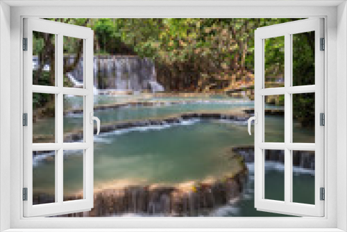 Fototapeta Naklejka Na Ścianę Okno 3D - Beautiful view of a small waterfall and cascades at the Tat Kuang Si Waterfalls near Luang Prabang in Laos on a sunny day.