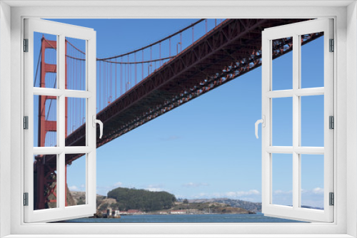 Fototapeta Naklejka Na Ścianę Okno 3D - View towards the northern tower of Golden Gate Bridge, from beneath, on the Pacific Ocean side, captured from a ferryboat connecting Sausalito to San Francisco, California, USA