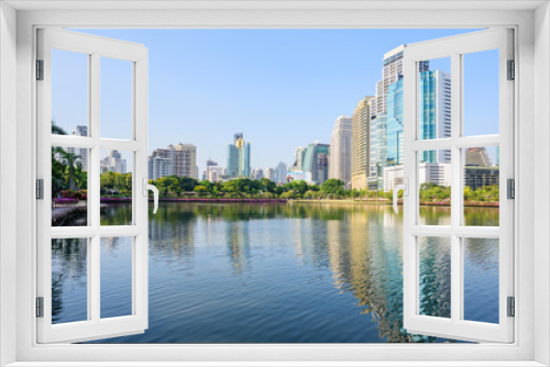Fototapeta Naklejka Na Ścianę Okno 3D - Lake view with reflections of the city / high building in the city lake view