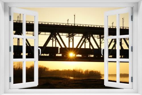 Fototapeta Naklejka Na Ścianę Okno 3D -  sun, sunset, bridge, river, shore, growth, orange, industry, wagons,spring