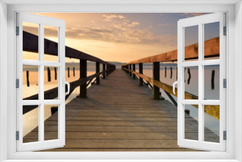 Fototapeta Naklejka Na Ścianę Okno 3D - Lake with Long Wooden Pier at Sunrise