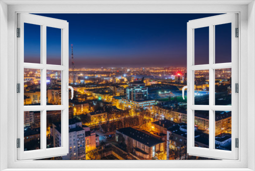 Fototapeta Naklejka Na Ścianę Okno 3D - Aerial view of night Voronezh downtown. Voronezh cityscape at blue hour. Urban lights, modern houses, television tower, stadium