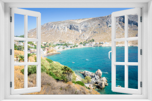 Fototapeta Naklejka Na Ścianę Okno 3D - Beautiful sunny coast view to the greek blue sea with crystal clear water beach with some boats fishing cruising surrounded by hills mountains, Kantouni, Patmos, Kos, Dodecanese Islands, Greece 