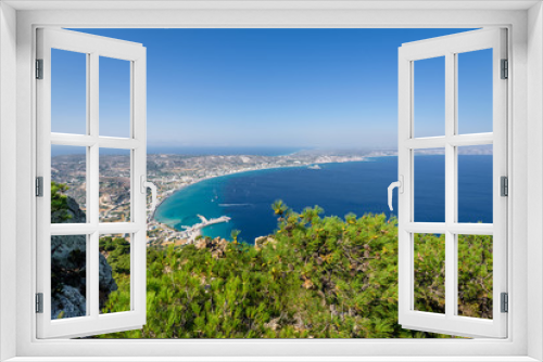 Fototapeta Naklejka Na Ścianę Okno 3D - Beautiful sunny coast view to the greek mediterranean blue sea with crystal clear water and pure sandy beach empty place with some mountains rocks surrounded, Kos, Dodecanese Islands, Greece