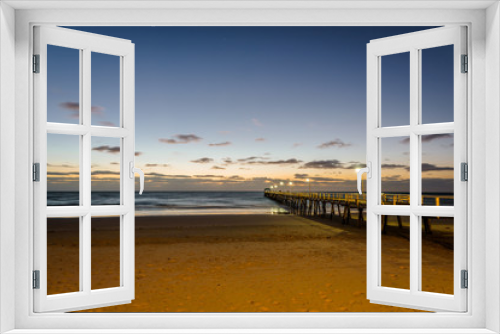 Fototapeta Naklejka Na Ścianę Okno 3D - Beautiful colorful sunset summer view to the calm great ocean with pure sandy beach and a lovely empty wooden jetty lighten the night at a public boulevard, Glenelg Jetty, Adelaide, South/ Australia