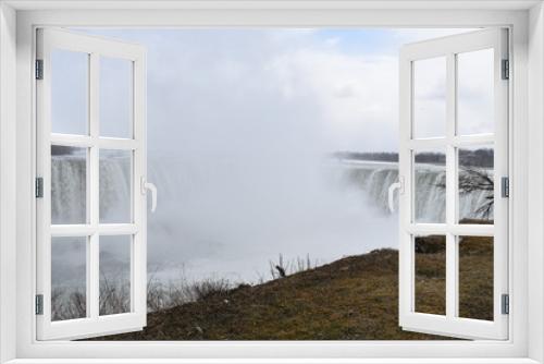 Fototapeta Naklejka Na Ścianę Okno 3D - Beautiful gigantic frozen Horseshoe Niagara Waterfalls on a frozen spring day in Niagara Falls in Ontario, Canada
