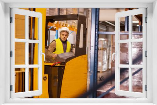 Automated production. Serious machine operation sitting in the vehicle cabin while doing his job