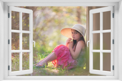 Fototapeta Naklejka Na Ścianę Okno 3D - Young girl wearing a pink sundress and hat outdoors at sunet.