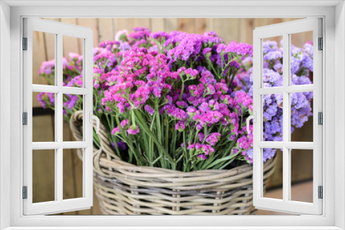 Fototapeta Naklejka Na Ścianę Okno 3D - In a wicker basket variety of limonium sinuatum or statice salem flowers in pink, lilac, violet colors in the garden shop.