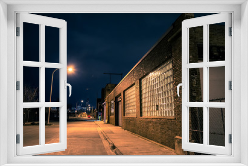 Fototapeta Naklejka Na Ścianę Okno 3D - Dark empty and scary urban city street road with alleys and vintage industrial factory and warehouse buildings at night in Chicago
