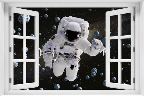 Fototapeta Naklejka Na Ścianę Okno 3D - astronaut flying between abstract geometric objects with starry background 