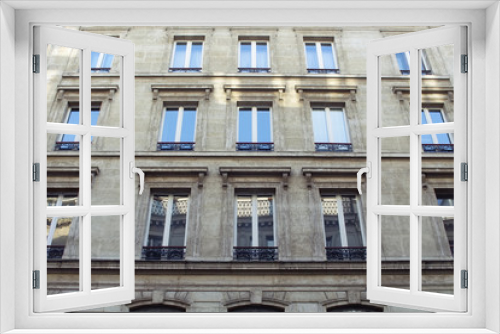 Fototapeta Naklejka Na Ścianę Okno 3D - Bottom view of a building in Paris showing French / Parisian architectural style.