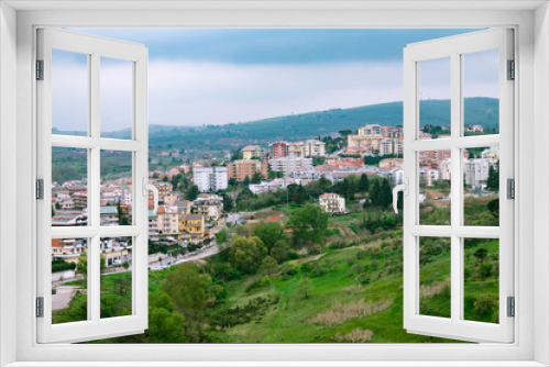 Fototapeta Naklejka Na Ścianę Okno 3D - View of the city from a height, a city between the mountains, частные houses on a hill