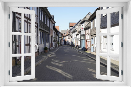 Fototapeta Naklejka Na Ścianę Okno 3D - Tiny street with old nordic style houses in the town of Goslar, Germany in the Harz region.