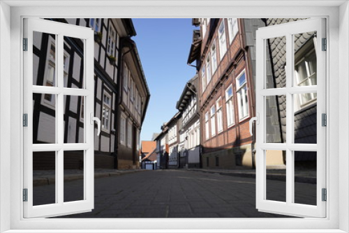 Fototapeta Naklejka Na Ścianę Okno 3D - Tiny street with old nordic style houses in the town of Goslar, Germany in the Harz region.