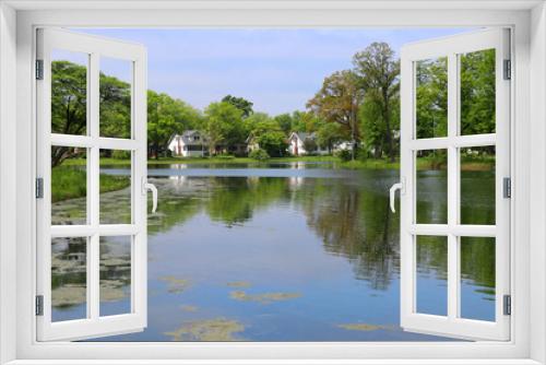 Fototapeta Naklejka Na Ścianę Okno 3D - Beautiful summer landscape  with cloudy blue sky reflected in a lake Mendota bay water and neighborhood buildings between fresh green trees on a background. Tenney Park,city of Madison, Wisconsin,USA.