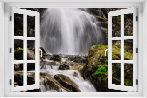 Fototapeta Naklejka Na Ścianę Okno 3D - Scenic waterfall flows through the wilderness in the mountains.