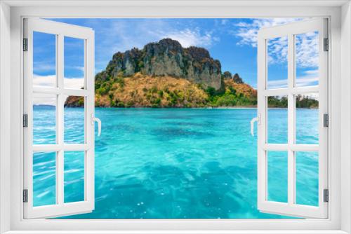 Fototapeta Naklejka Na Ścianę Okno 3D - Spectacular scenery the tropical island with the limestone cliffs covered with the vegetation in the crystal clear ocean next to the exotic Phi Phi Islands, the Kingdom of Thailand. Paradise image.
