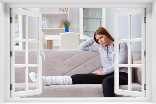 Young woman with broken leg at home