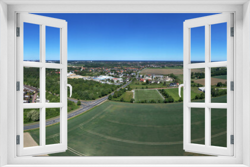 Fototapeta Naklejka Na Ścianę Okno 3D - Aerial view of the eastern edge of Wolfburg, with fields and meadows in the foreground and two districts at the back.