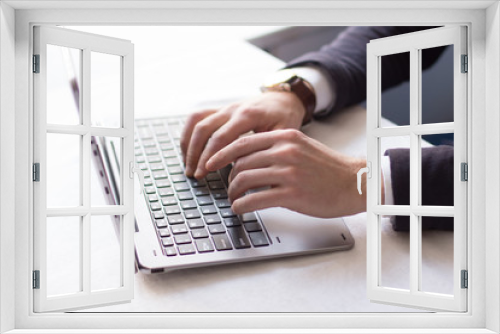 Fototapeta Naklejka Na Ścianę Okno 3D - Closeup of businessman typing on laptop. Communicating with partners. Business concept.