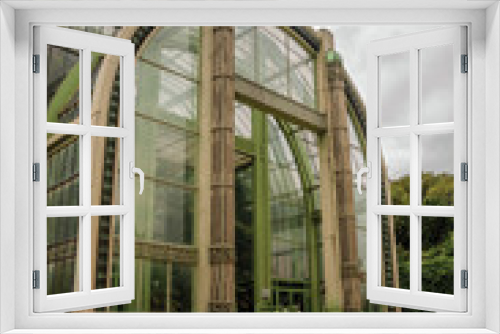 Fototapeta Naklejka Na Ścianę Okno 3D - Winter Garden facade, a Deco greenhouse for non-native plants in the Garden of Plants in Paris. Known as the “City of Light”, is one of the most impressive world’s cultural center. Northern France.