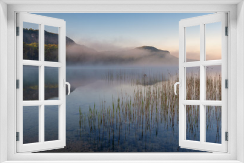 Fototapeta Naklejka Na Ścianę Okno 3D - French landscape - Jura. View over the lake of Ilay in the Jura mountains (France) at sunrise with reeds in the foreground.