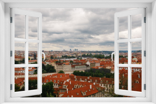 Fototapeta Naklejka Na Ścianę Okno 3D - Czech Republic, Prague, July 25, 2017: Panoramic view of the city. Red Roofs of houses and structures of the old city in the summer in cloudy cloudy weather