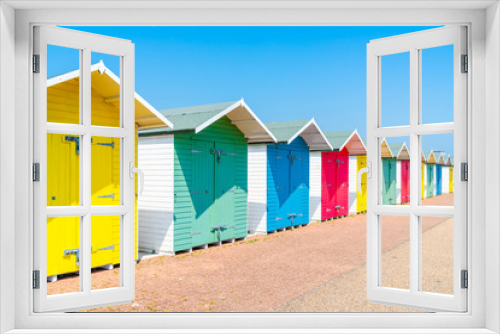 Fototapeta Naklejka Na Ścianę Okno 3D - A row of colorful wooden beach huts on the beach in Eastbourne, East Sussex, UK