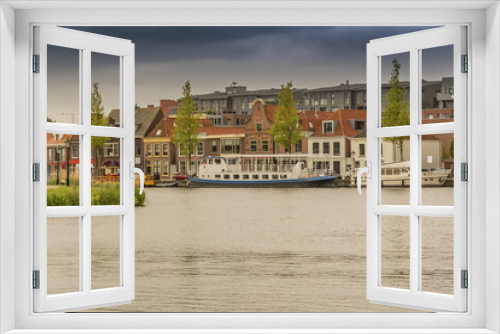 moored boats and houses in alkmaar. netherlands holland