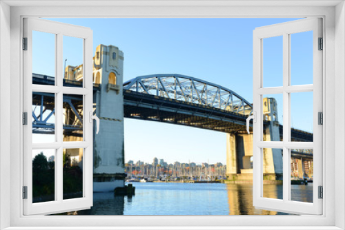 Fototapeta Naklejka Na Ścianę Okno 3D - Vancouver Burrard Bridge is an Art Deco style bridge crossing False Creek between downtown Vancouver and Kitsilano, British Columbia, Canada.